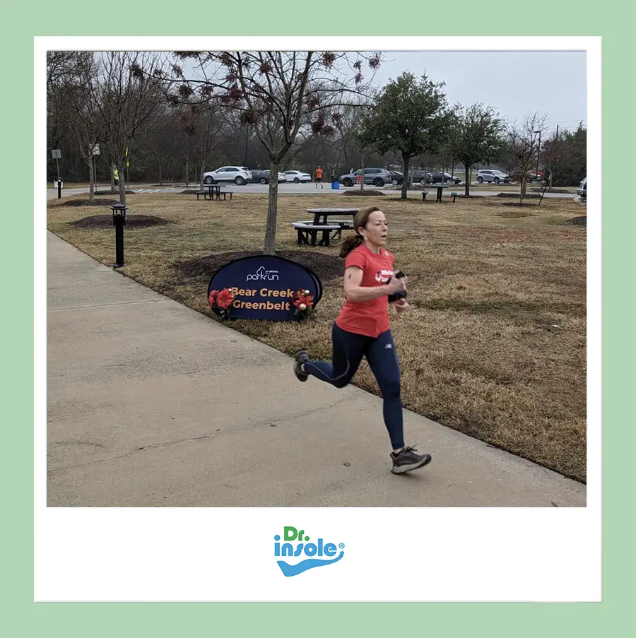 Runner using custom orthotic insoles during an outdoor park run.