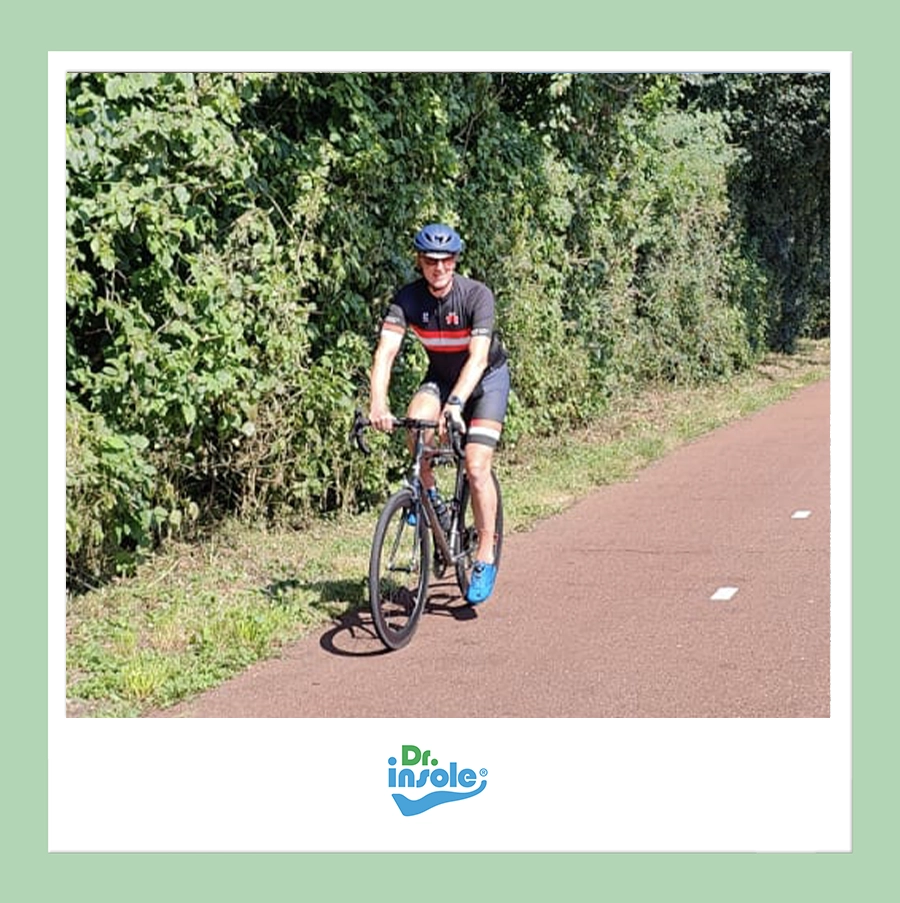 Cyclist riding outdoors wearing custom orthotic insoles by Dr Insole